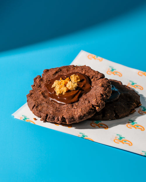 Chocolate afghan cookies with a filling on a blue background