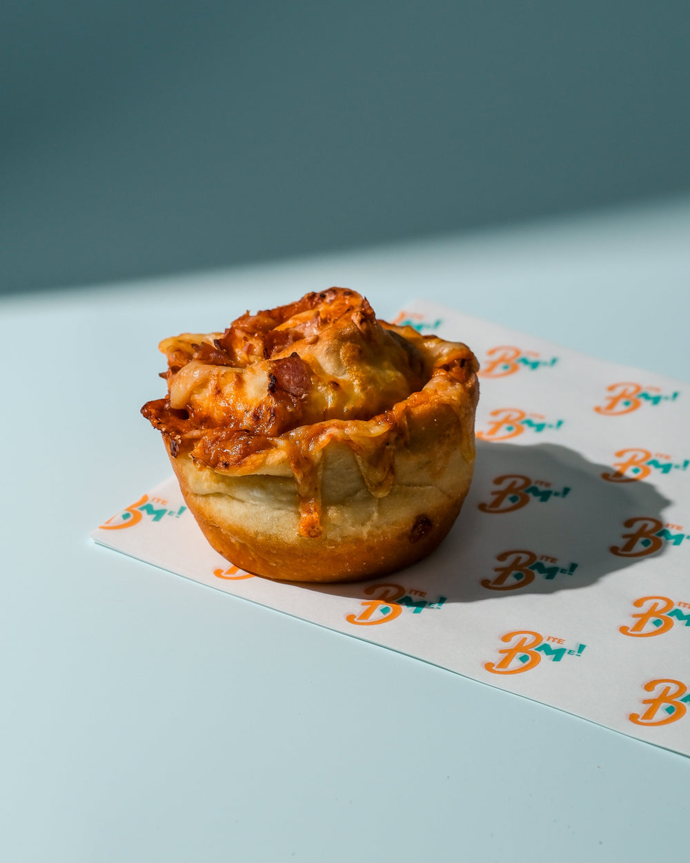 Pizza cheese scroll a branded paper with a blue background