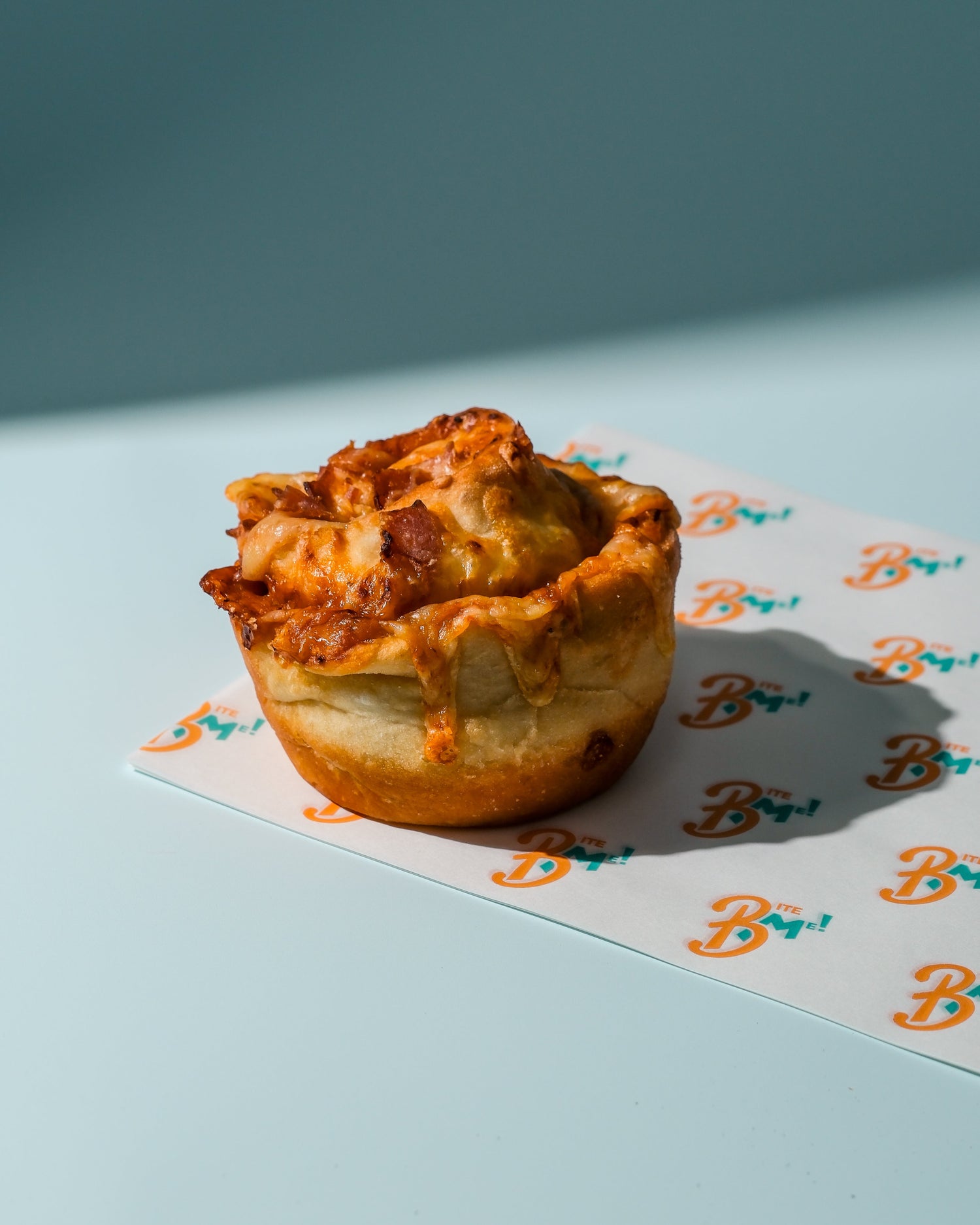 Pizza cheese scroll a branded paper with a blue background