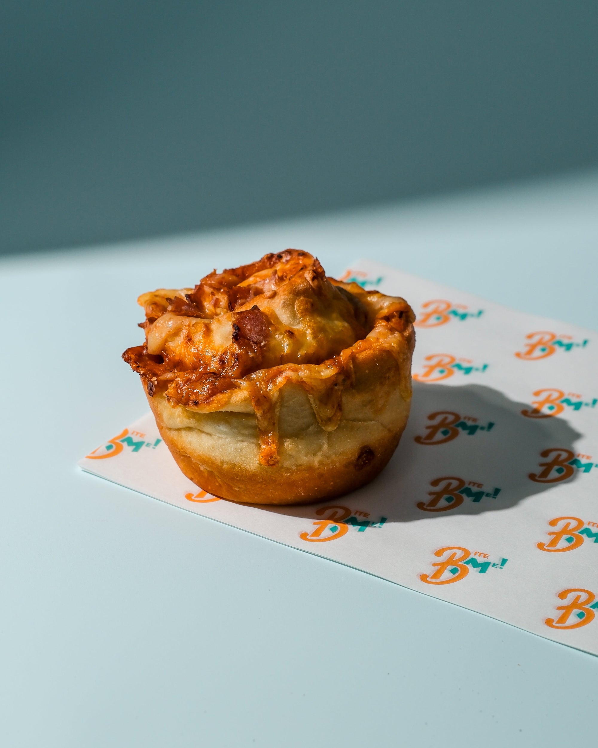 Pizza cheese scroll a branded paper with a blue background